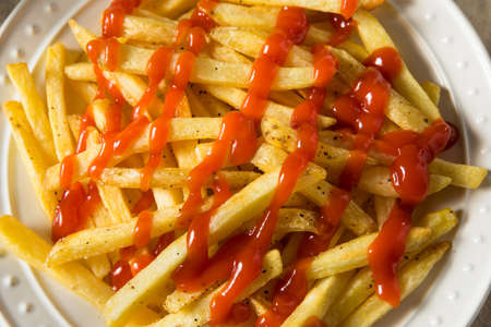 Homemade French Fries with Ketchup with Salt and Pepperの写真素材