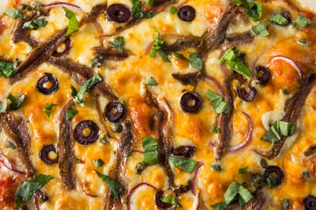 Homemade Gourmet Anchovy PIzza with Olives and Basilの写真素材