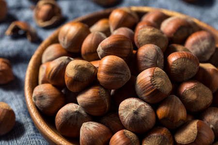 Raw Organic Unshelled Hazelnuts in a Bowlの写真素材