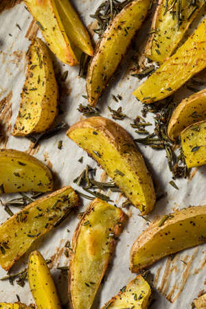 Homemade Organic Rosemary Potato Wedges with Salt and Pepperの写真素材