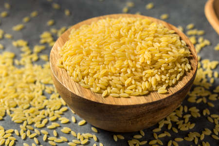 Raw Organic Dry Orzo Pasta in a Bowlの写真素材