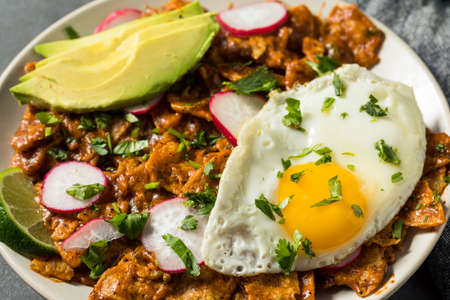 Homemade Mexican Chilaquiles for Breakfast with Egg and Avocadoの写真素材