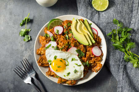 Homemade Mexican Chilaquiles for Breakfast with Egg and Avocadoの写真素材