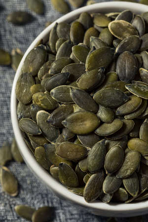 Healthy Organic Raw Pumpkin Seed Pepitas in a Bowlの写真素材