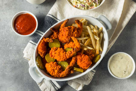 Homemade Nashville Hot Fried Shrimp with Fries and Picklesの写真素材