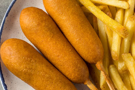 Homemade Breaded Beef Corndogs with French Friesの写真素材