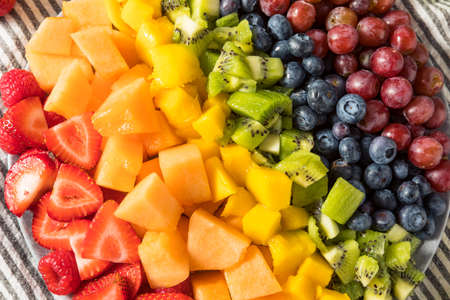 Raw Organic Rainbow Fruit Salad with Berries Melons and Grapesの写真素材