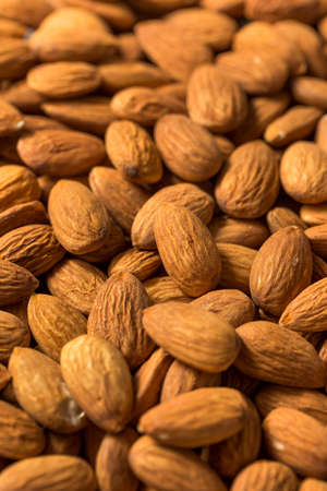 Raw Organic Brown Almonds in a Bowlの写真素材