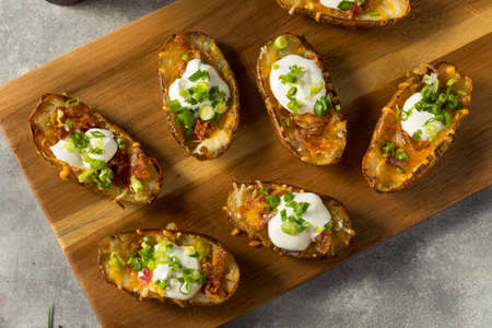 Homemade Loaded Crispy Potato Skins with Sour Cream and Baconの写真素材