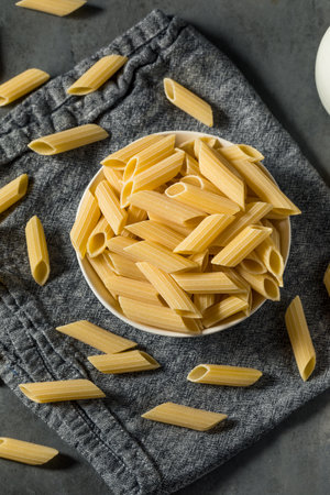 Raw Organic Pennoni Pasta in a Bowlの写真素材