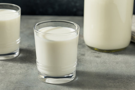 Organic Grass Fed Whole Cow Milk in a Glassの写真素材