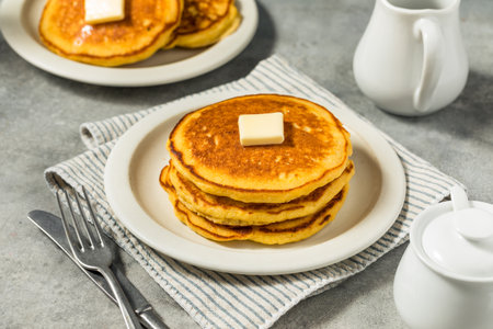 Homemade Breakfast Corn Cake Pancakes with Butter and Syrup