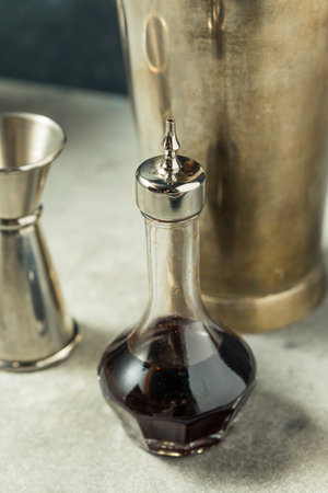Homemade Brown Cocktail Bitters Ready to Use in a Drink