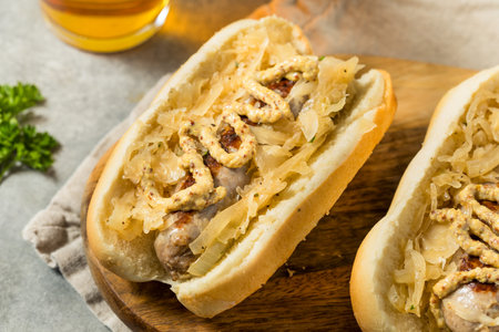 German Homemade Bratwurst Sandwiches with Sauerkraut and Beer for Oktoberfestの写真素材