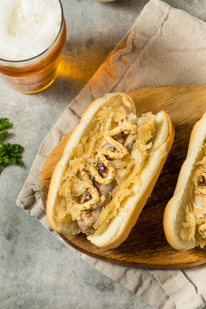 German Homemade Bratwurst Sandwiches with Sauerkraut and Beer for Oktoberfestの写真素材