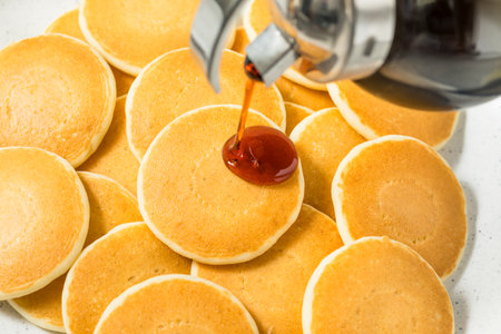 Homemade Mini Silver Dollar Pancakes for Breakfast with Butter and Syrupの写真素材