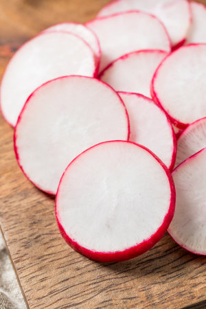 Organic Red Cut Radish Slices on a Cutting Boardの写真素材