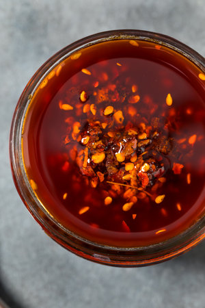 Homemade Spicy Chili Crisp Oil Sauce with Peppers and Seedsの写真素材