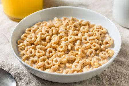 Healthy Round Oat Breakfast Cereal with Whole Milk and Juiceの写真素材