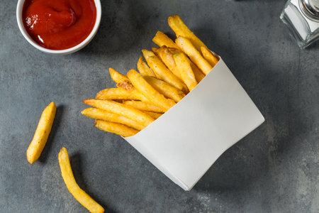 Homemade Fast Food Golden French Fries with Tomato Ketchupの写真素材