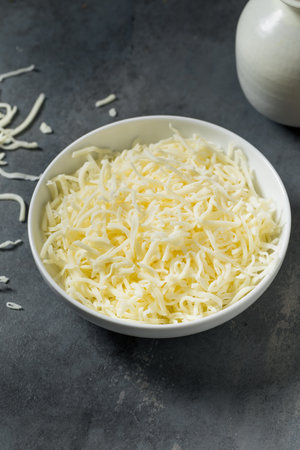 Organic Shredded Mozzarella Cheese in a Bowl for Cookingの写真素材