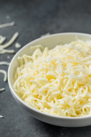 Organic Shredded Mozzarella Cheese in a Bowl for Cookingの写真素材