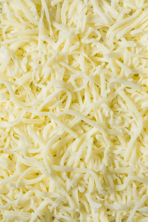 Organic Shredded Mozzarella Cheese in a Bowl for Cookingの写真素材