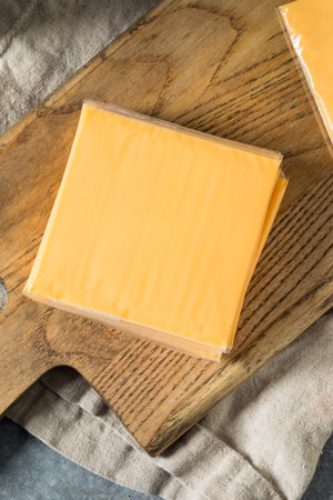 Unhealthy Wrapped American Cheese Slices in a Pile