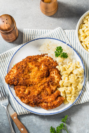 Homemade German Chicken Weiner Schnitzel with Speatzleの写真素材