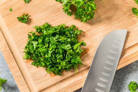 Raw Green Organic Minced Parsley on a Cutting Boardの写真素材