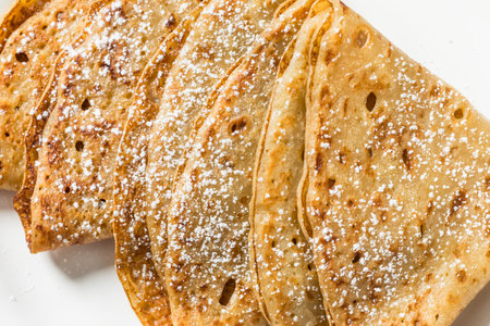 Sweet Homemade French Crepes with Powdered Sugar and Butter
