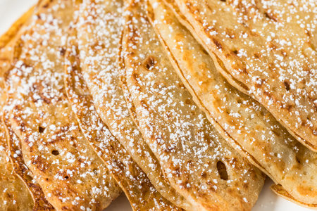 Sweet Homemade French Crepes with Powdered Sugar and Butter