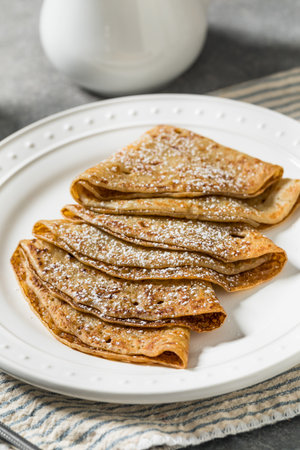 Sweet Homemade French Crepes with Powdered Sugar and Butter
