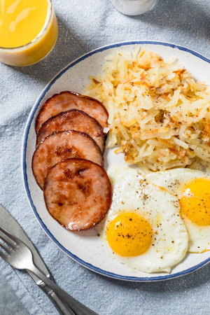Homemade Eggs Canadian Bacon and Hash Brown Breakfast with Toastの写真素材