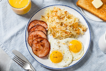 Homemade Eggs Canadian Bacon and Hash Brown Breakfast with Toastの写真素材