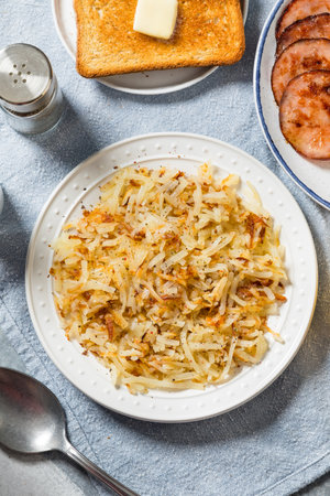 Healthy homemade crispy shredded hashbrowns with salt and pepperの写真素材