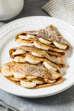 Sweet Homemade Chocolate Banana French Crepes with Powdered Sugarの写真素材