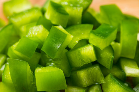 Organic Diced Green Bell Peppers on a Cutting Boardの写真素材