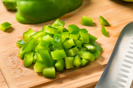 Organic Diced Green Bell Peppers on a Cutting Boardの写真素材