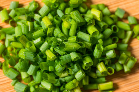 Raw Diced Cut Chives on a Cutting Boardの写真素材