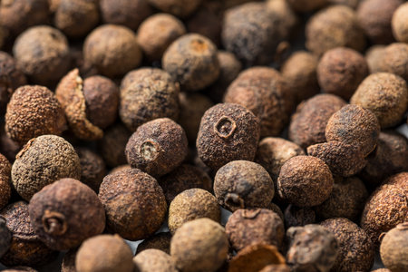 Dry Organic Allspice Berries in a Spoon to Cook With