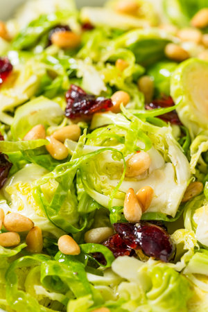 Healthy Fall Shaved Brussel Sprout Salad with PIne Nuts and Cranberriesの写真素材