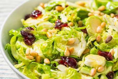 Healthy Fall Shaved Brussel Sprout Salad with Pine Nuts and Cranberriesの写真素材