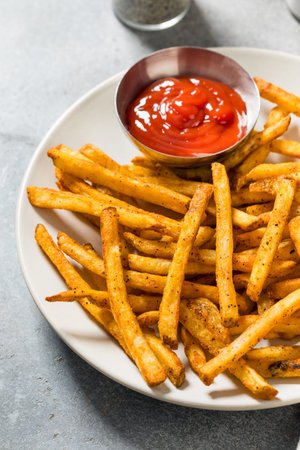 Homemade Spicy Seasoned French Fries with Ketchup on a Plate