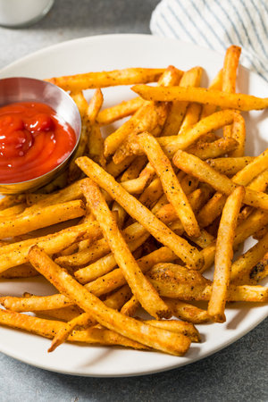 Homemade Spicy Seasoned French Fries with Ketchup on a Plate