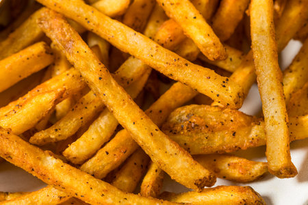 Homemade Spicy Seasoned French Fries with Ketchup on a Plate