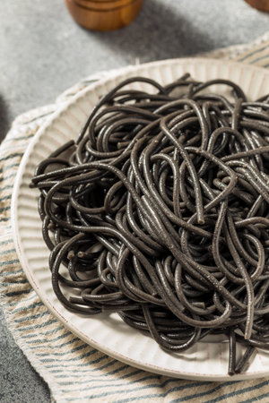 Homemade Italian Black Squid Ink Pasta on a Plateの写真素材