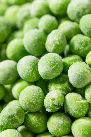 Organic Raw Frozen Green Sweet Peas in a Bowl