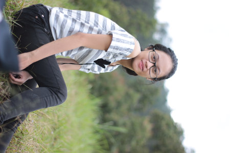 young asian woman relaxing on the top of a mountain with her eyes closed
