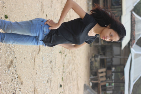 Beautiful young asian woman in black t-shirt and jeansの写真素材